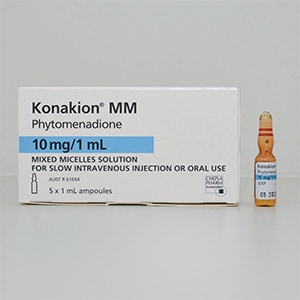 Medication box with the name Konakion MM. A vial next to the box.